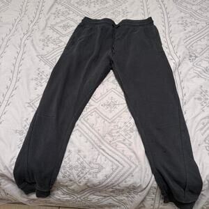 Woman’s Gymshark black sweatpants with white logo  size M
